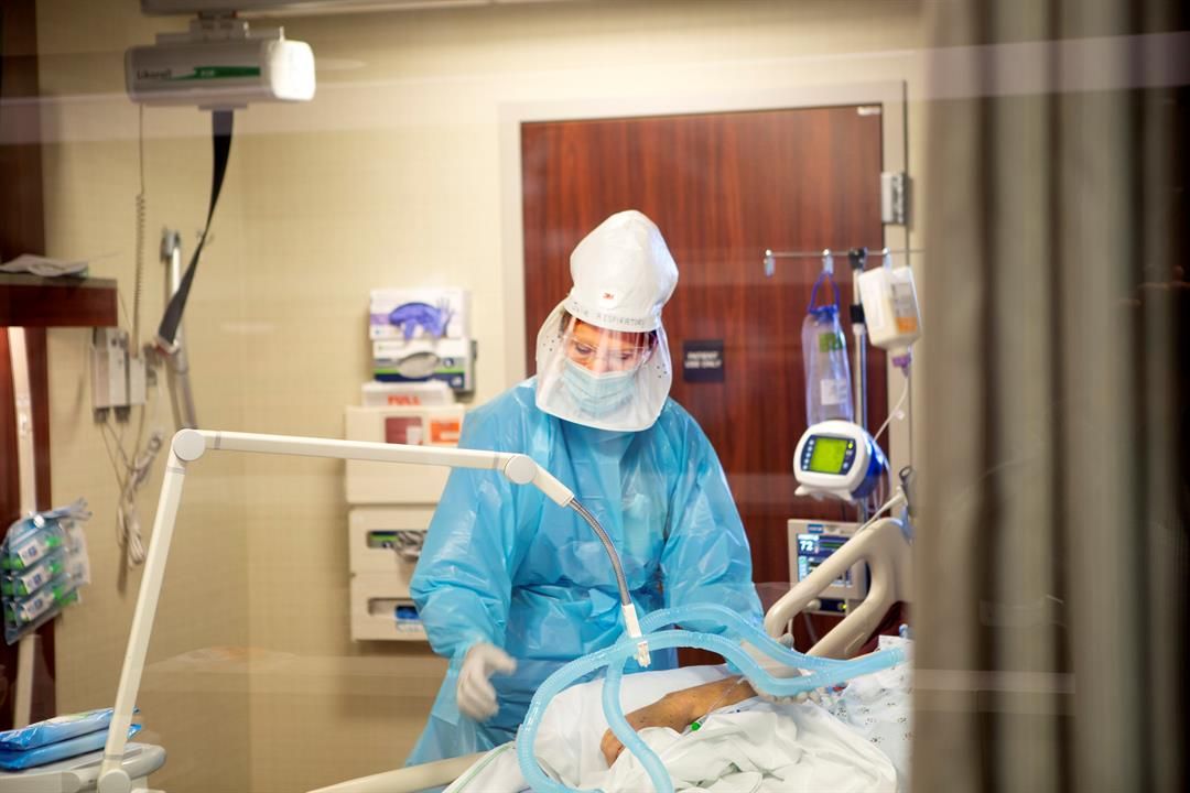 Julie Bornemeier, respiratory therapist, cares for a patient inside the sixth floor COVID-19 unit at Bryan East Campus in Lincoln.